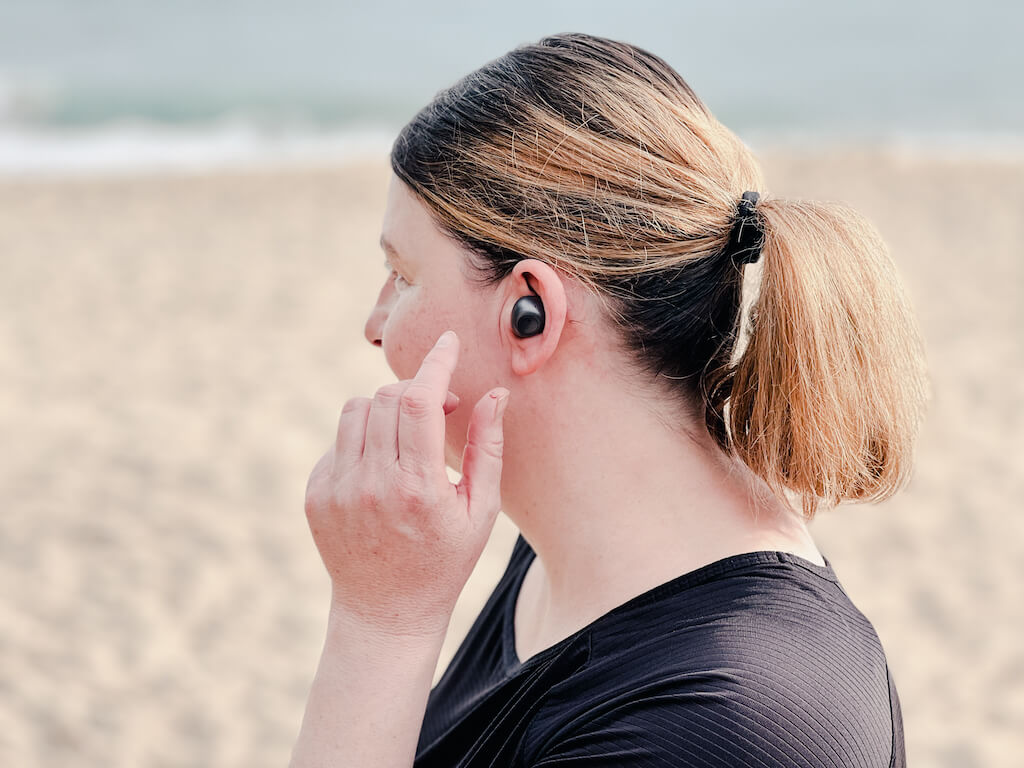 Frau mit In-Ear-Kopfhörern